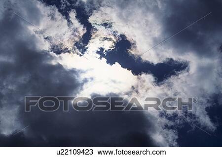 Stock Image - Sun Behind Clouds. Fotosearch