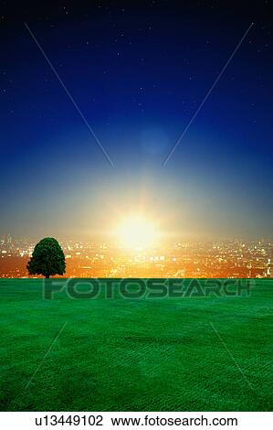 Stock Image - Sunrise over cityscape, digital composite. Fotosearch