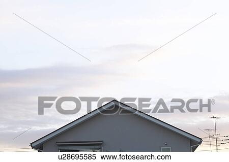 Stock Photography - Top of house and sky at dusk. Fotosearch