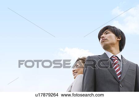 Two Businesspeople Standing Back To Back View Large Photo Image Picture - Two Businesspeople Standing Back To Back. Fotosearch