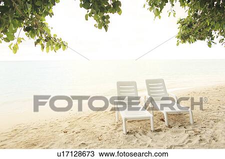 Stock Image - Two Lounge Chairs on beach. Fotosearch