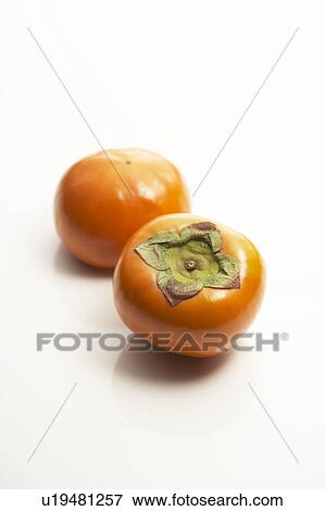 Two persimmons View Large Photo Image Stock Photo - Two persimmons. Fotosearch