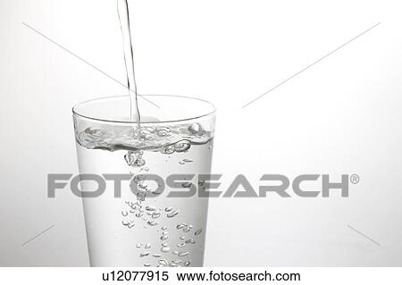 Stock Photography - Water being poured into glass. Fotosearch