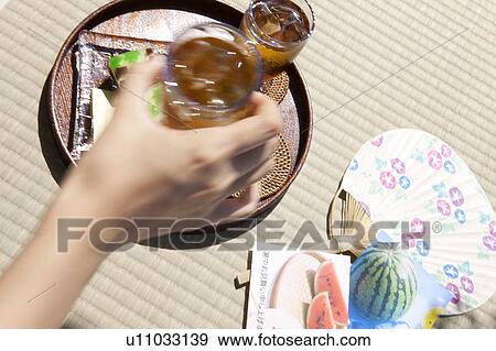 Woman holding glass of barley tea View Large Photo Image Stock Photo - Woman holding glass of barley tea. Fotosearch