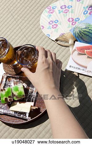 Woman holding glass of barley tea View Large Photo Image Stock Photo - Woman holding glass of barley tea. Fotosearch