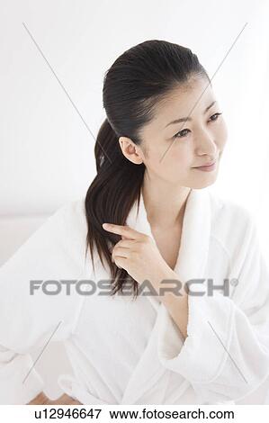 Stock Photo - Woman touching her hair. Fotosearch