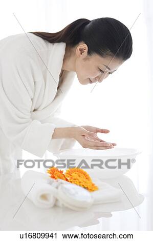 Woman washing her face View Large Photo Image Stock Image - Woman washing her face. Fotosearch