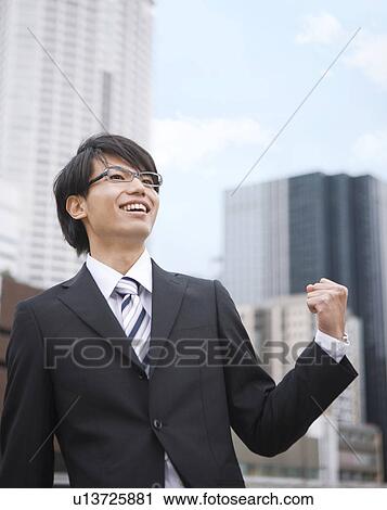 Young businessman making a fist View Large Photo Image Stock Image - Young businessman making a fist. Fotosearch