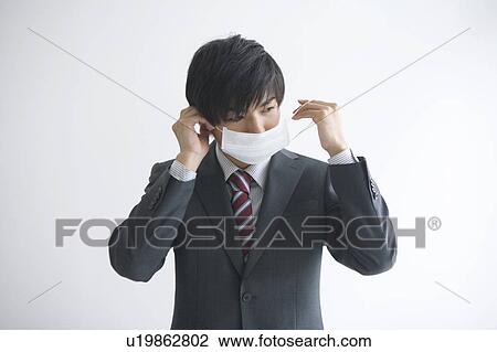 Young businessman wearing a flu mask View Large Photo Image Stock Image - Young businessman wearing a flu mask. Fotosearch