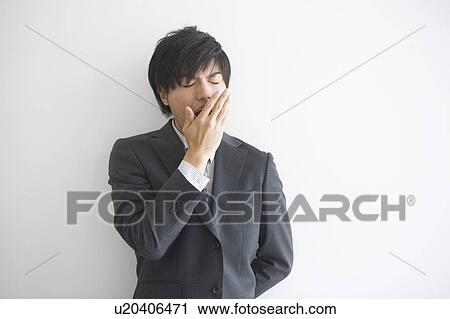 Young businessman yawning View Large Photo Image Stock Image - Young businessman yawning. Fotosearch