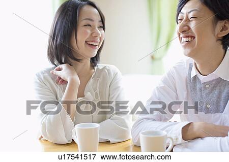 Stock Photo - Young Couple Chatting Over Cup of Coffee. Fotosearch