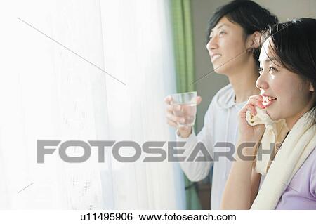 Stock Photograph - Young Couple Cooling Down After Exercise. Fotosearch