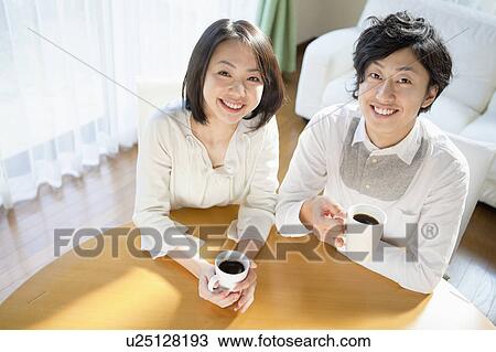 Stock Image - Young Couple Drinking Coffee. Fotosearch