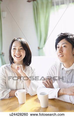 Stock Image - Young Couple Having Cup of Coffee. Fotosearch