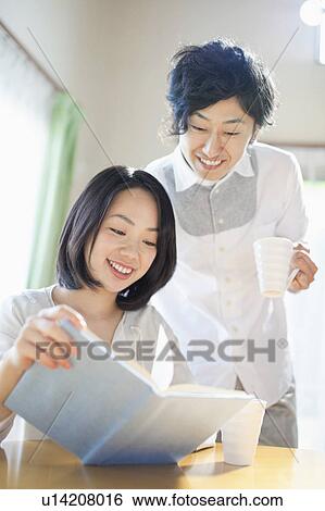 Young Couple Looking at Book View Large Photo Image Stock Photograph - Young Couple Looking at Book. Fotosearch