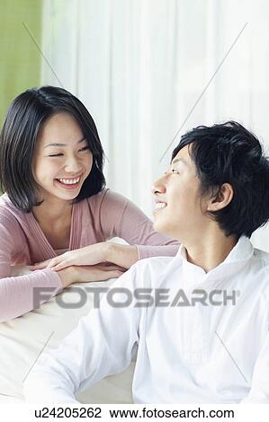 Stock Image - Young Couple Looking at Each Other. Fotosearch