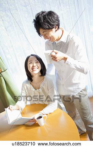 Young Couple Relaxing by Table View Large Photo Image Stock Image - Young Couple Relaxing by Table. Fotosearch