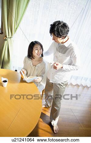 Young Couple Relaxing in Living Room View Large Photo Image Picture - Young Couple Relaxing in Living Room. Fotosearch