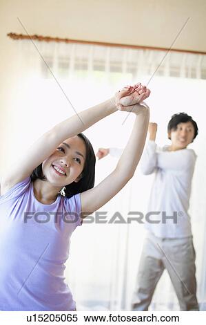 Stock Photography - Young Couple Stretching. Fotosearch