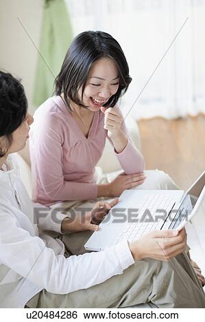 Stock Photograph - Young Couple Using Laptop. Fotosearch