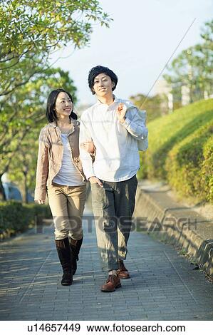 Stock Photo - Young Couple Walking. Fotosearch