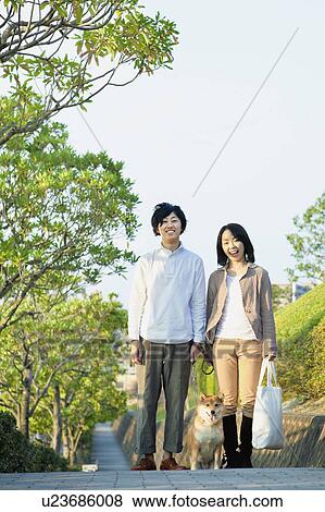 Stock Photo - Young Couple with a Dog. Fotosearch