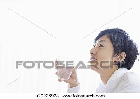 Young Man Contemplating with Water Glass in Hand View Large Photo Image Stock Photo - Young Man Contemplating with Water Glass in Hand. Fotosearch