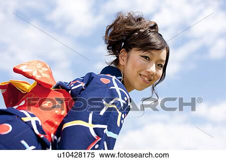 Stock Photography - Young woman in Yukata looking at camera. Fotosearch