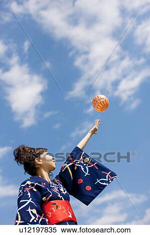 Young woman in Yukata playing with paper balloon View Large Photo Image Stock Photography - Young woman in Yukata playing with paper balloon. Fotosearch