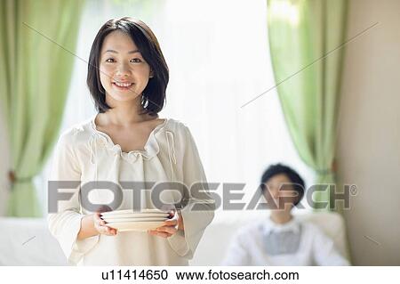 Stock Image - Young Woman Setting The Table. Fotosearch