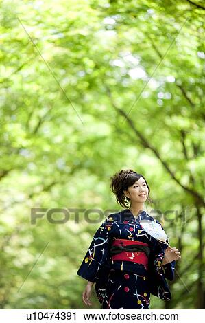 Young woman walking in Yukata View Large Photo Image Stock Image - Young woman walking in Yukata. Fotosearch