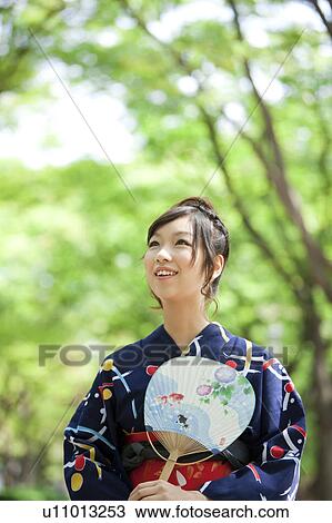 Young woman wearing Yukata and holding a fan View Large Photo Image Stock Image - Young woman wearing Yukata and holding a fan. Fotosearch