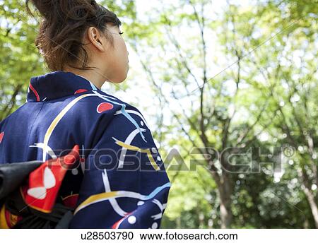 Stock Image - Young woman wearing Yukata, rear view. Fotosearch