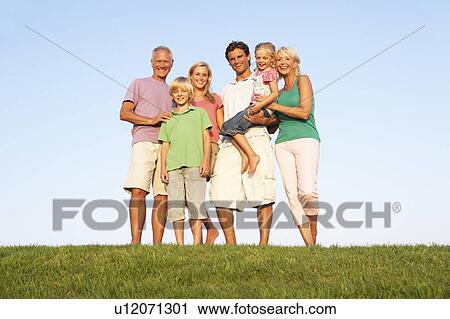 A family, with parents, children and grandparents, posing in a field View Large Photo Image Stock Image - A family, with parents, children and grandparents, posing in a field. Fotosearch