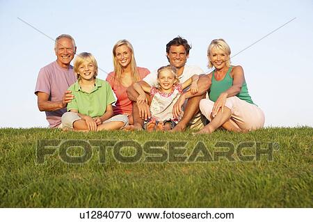 A family, with parents, children and grandparents, posing in a field View Large Photo Image Stock Image - A family, with parents, children and grandparents, posing in a field. Fotosearch