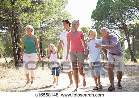 Stock Photo - A family, with parents, children and grandparents, walk through park. Fotosearch