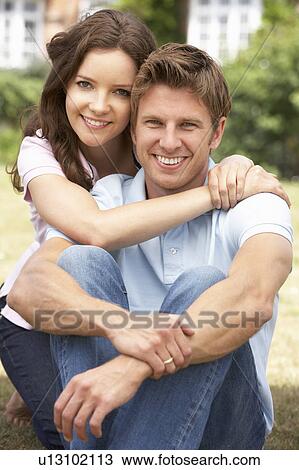 Affectionate Couple Relaxing At Home In Garden Together View Large Photo Image Stock Image - Affectionate Couple Relaxing At Home In Garden Together. Fotosearch