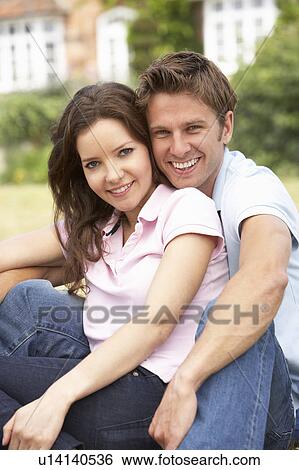 Affectionate Couple Relaxing At Home In Garden Together View Large Photo Image Stock Photograph - Affectionate Couple Relaxing At Home In Garden Together. Fotosearch