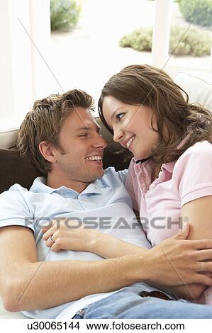 Picture - Affectionate Couple Relaxing At Home Together. Fotosearch