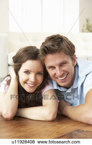 Affectionate Couple Relaxing At Home Together View Large Photo Image Stock Photo - Affectionate Couple Relaxing At Home Together. Fotosearch