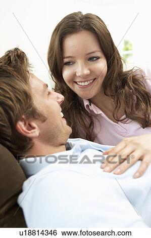 Stock Photograph - Affectionate Couple Relaxing At Home Together. Fotosearch