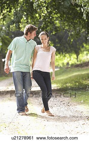 Affectionate Couple Walking In Countryside Together View Large Photo Image Stock Image - Affectionate Couple Walking In Countryside Together. Fotosearch
