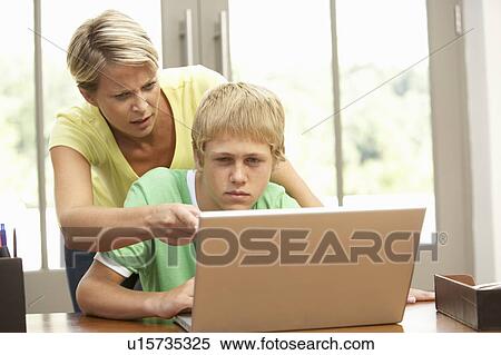 Angry Mother And Teenage Son Using Laptop At Home View Large Photo Image Stock Photography - Angry Mother And Teenage Son Using Laptop At Home. Fotosearch