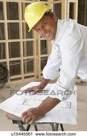 Architect Studying Plans In New Home View Large Photo Image Stock Image - Architect Studying Plans In New Home. Fotosearch