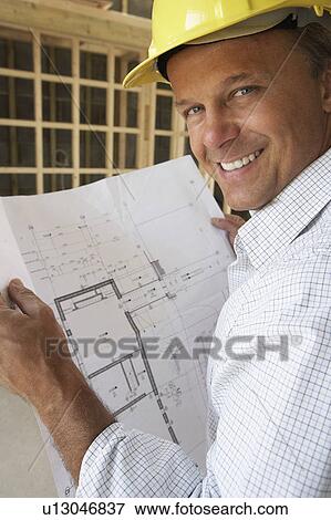 Architect With Plans In New Home View Large Photo Image Stock Photo - Architect With Plans In New Home. Fotosearch