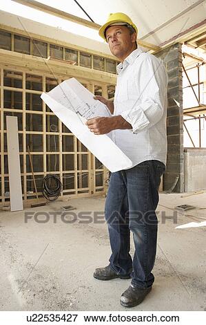 Architect With Plans In New Home View Large Photo Image Stock Photo - Architect With Plans In New Home. Fotosearch