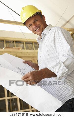 Architect With Plans In New Home View Large Photo Image Stock Photo - Architect With Plans In New Home. Fotosearch