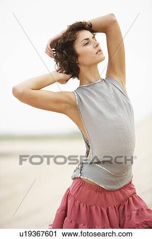 Attractive Young Woman Wearing Revealing Clothing Standing Amongst Sand Dunes View Large Photo Image Stock Image - Attractive Young Woman Wearing Revealing Clothing Standing Amongst Sand Dunes. Fotosearch