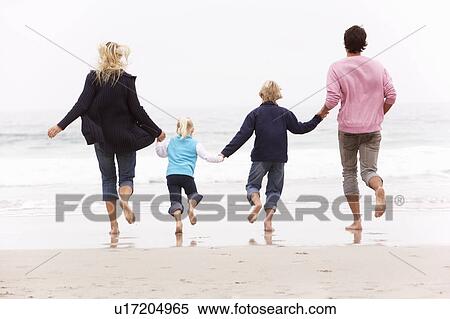 Back View Of Young Family Running Along Winter Beach View Large Photo Image Stock Photography - Back View Of Young Family Running Along Winter Beach. Fotosearch