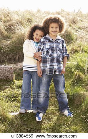 Boy And Girl Playing In Field Together View Large Photo Image Stock Photo - Boy And Girl Playing In Field Together. Fotosearch